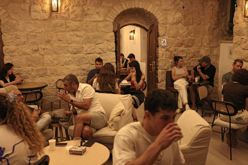 Israelis sit in Cafe Basimta in central Jerusalem
