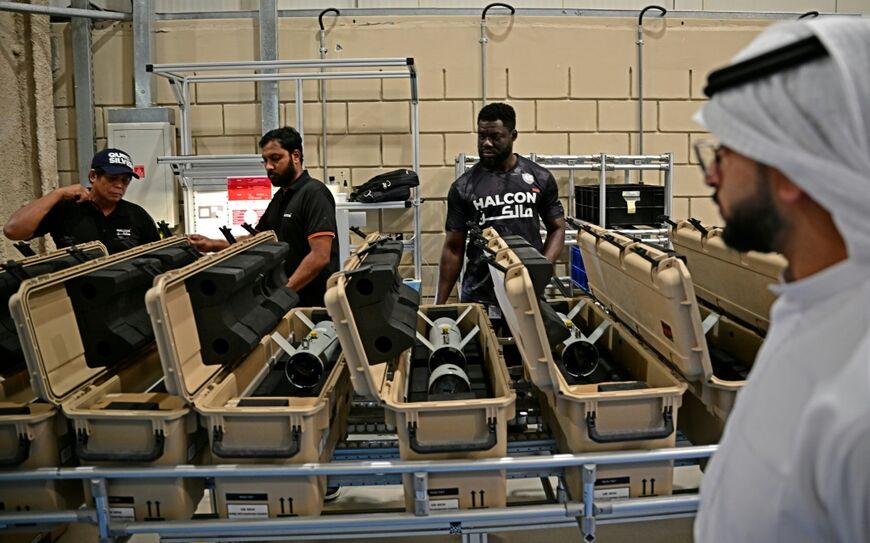 The acting chief executive officer of Halcon, Saeed Al Shamsi, inspects the assembly line of guided ammunition