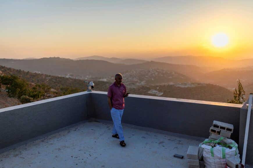 Qusai, the brother of US-Palestinian dual citizen Louai Abu Ridi, whose home in the occupied West Bank village of Qusra is besieged by Israeli settlers, walks on the roof of the home in Qusra