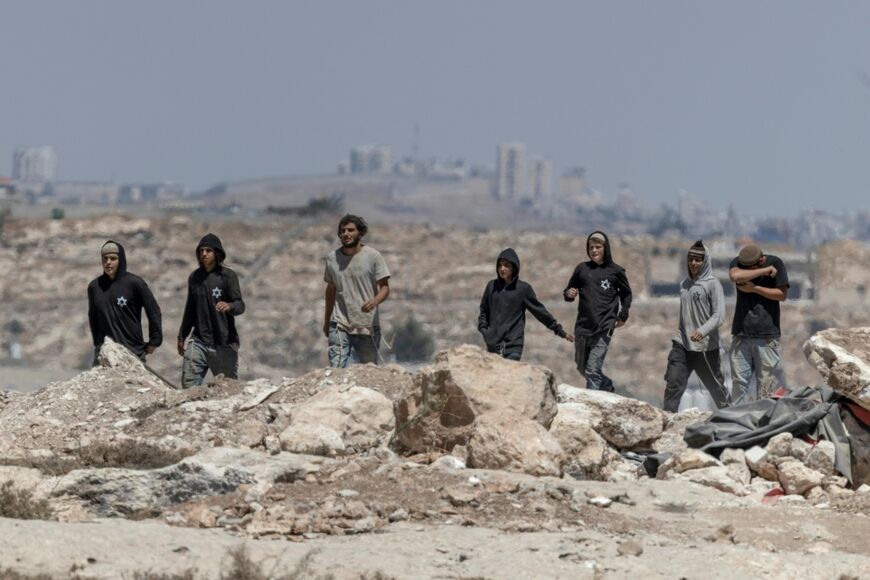 Israeli settlers arrive to confront left-wing activists at an Israeli outpost in the Palestinian village of Jannatah, just south of the city of Bethlehem in the West Bank, on August 25, 2026