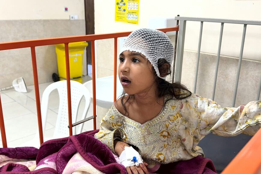 Iranian officials say the United States committed a 'war crime' in Sirik, where a hospitalized child received treatment following injuries from an overnight strike, in a photo obtained by AFP from the Iranian news agency Tasnim