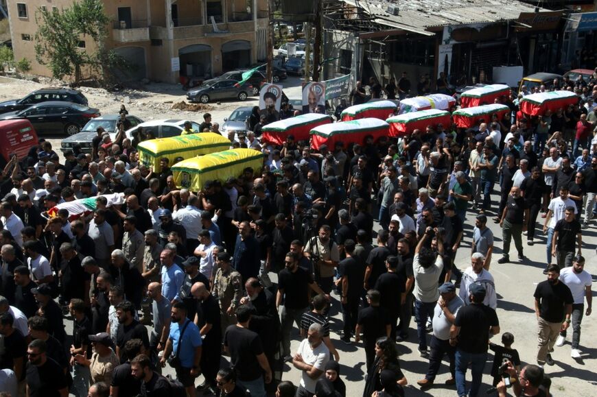 Mourners carry the coffins of people killed in an Israeli air strike that targeted the southern Lebanese village of Kfar Rumman