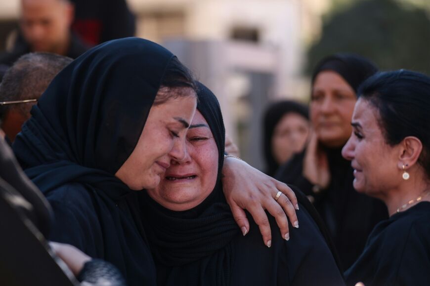 People march to the cemetery in Kfar Rumman, Lebanon, as an Israeli drone flies overhead