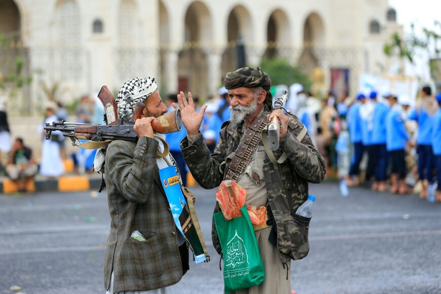 Supporters of the Houthi authorities hold weapons during a protest against Saudi Arabia in Sanaa on September 18