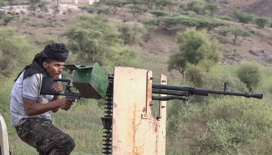 This frame grab taken from AFPTV video footage on September 9, 2026, shows a member of the Saudi-backed Yemeni government forces firing a heavy machine gun during clashes with Houthi fighters in the Al-Kadha area, west of Taiz province, on September 8, 2026. 