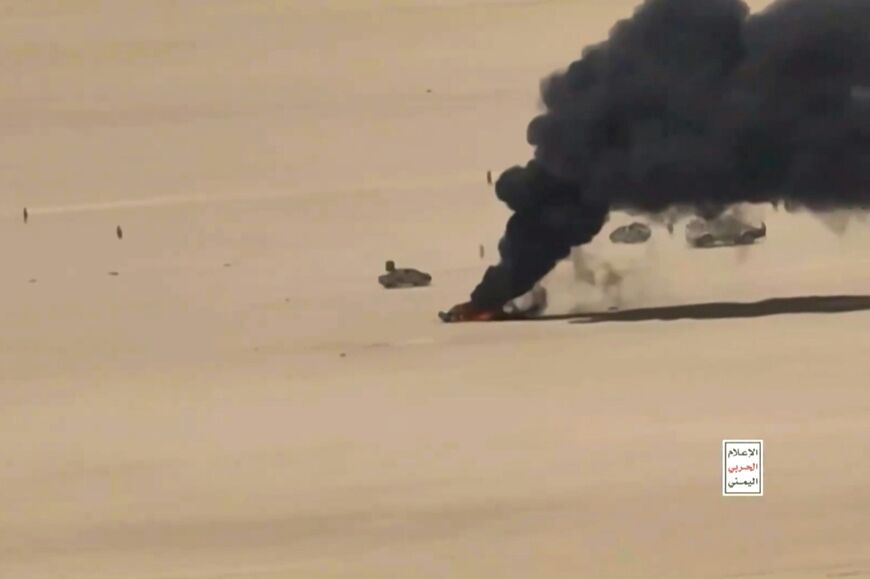 This screen grab taken from video footage released by Ansarullah Media Centre on October 5 shows an aerial view of a burning vehicle during what the Houthis say are drone attacks on Yemeni government forces