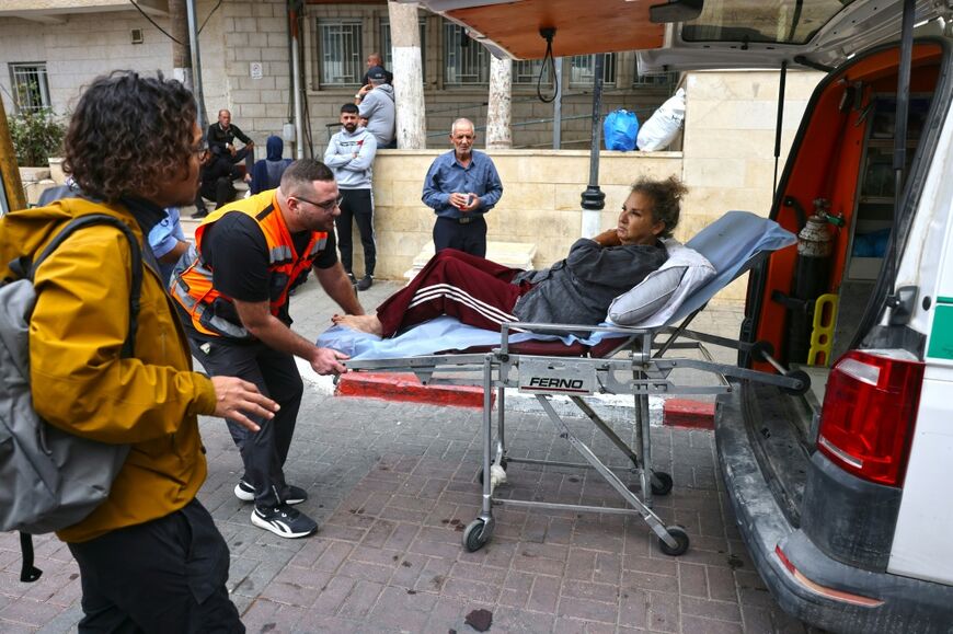 American photojournalist Heidi Levine is transferred on a stretcher into a Palestinian ambulance in Ramallah