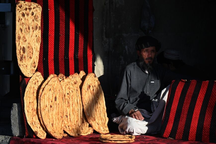 An Afghan vendor waiting for customers at his bakery on a street in Kandahar