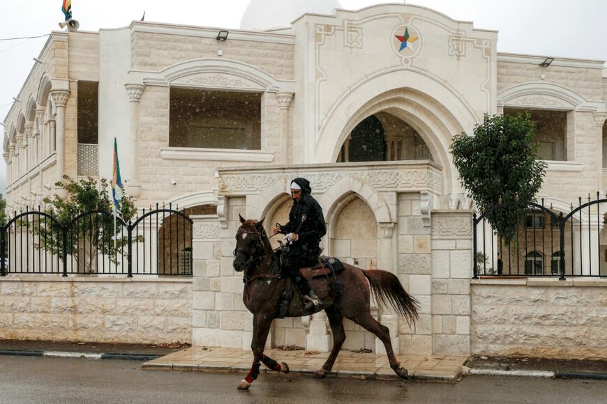 A Druze man rides a horse near the Druze shrine of Nabi al-Yafouri in the Druze town of Majdal Shams in the Israeli-annexed Golan Heights
