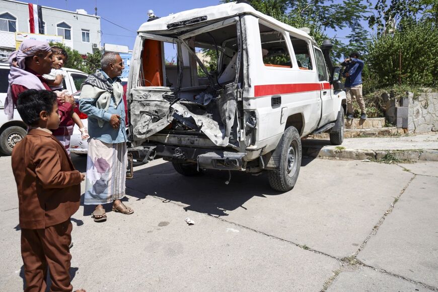 A damaged ambulance in front of Al-Thawra General Hospital in Taiz. The WHO says hospitals in the city are struggling