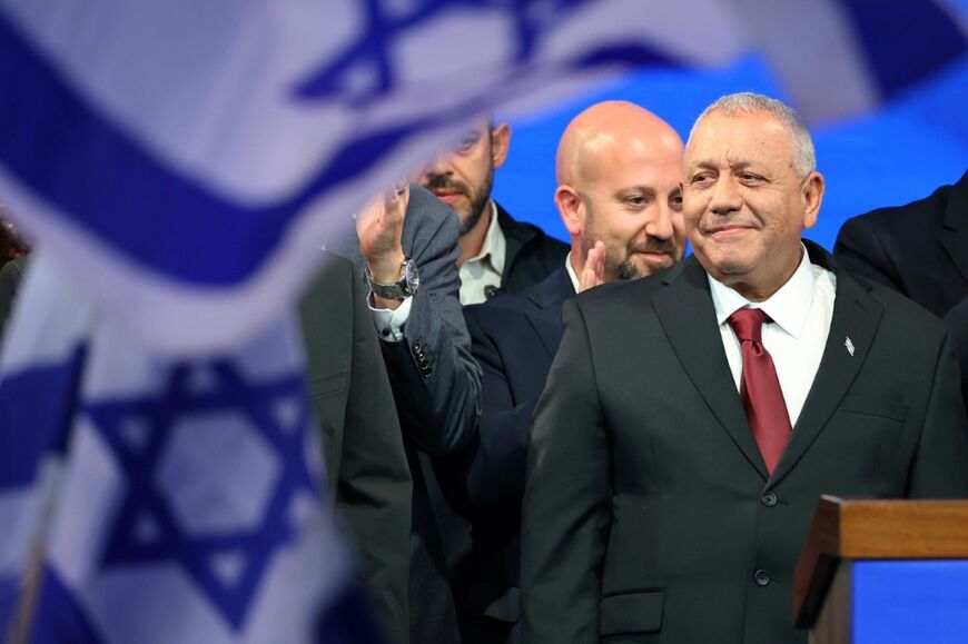 Yashar party leader Gadi Eisenkot (R) arrives to address his supporters at the election night rally after the first exit polls were announced, in Tel Aviv