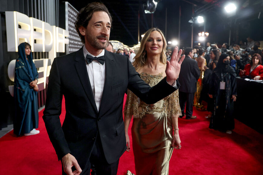 In this handout photo released by the Red Sea International Film Festival (RSFF), US actor Adrien Brody and his wife US actress Georgina Chapman arrive on the red carpet of the closing ceremony of the third edition of the Red Sea International Film Festival in Jeddah on December 07, 2023. (Photo by PATRICK BAZ / Red Sea Film Festival / AFP)
