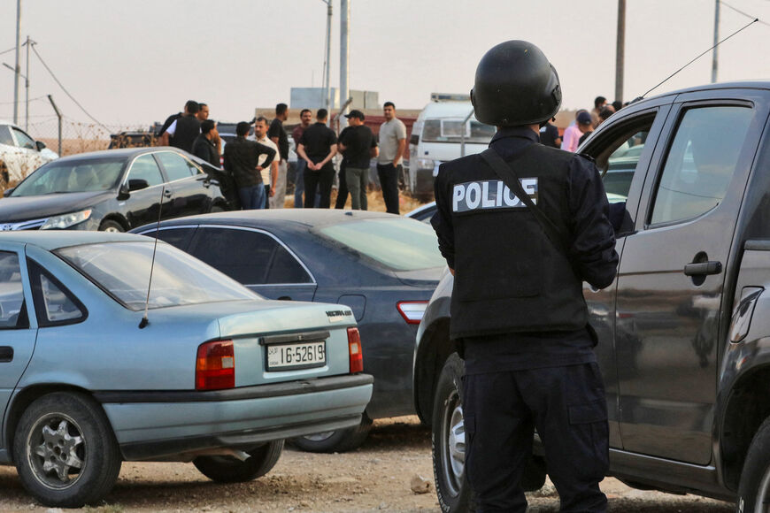 People and security forces gather outside of the Hamoud Church in Jordan's Karak governorate following a shooting on October 23, 2026. (Photo by AFP via Getty Images)