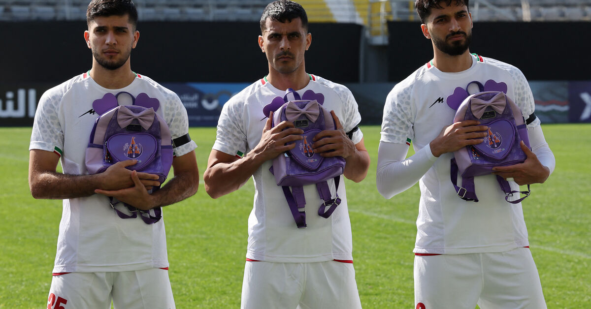 Soccer - Iranian players hold schoolbags in solidarity with slain girls