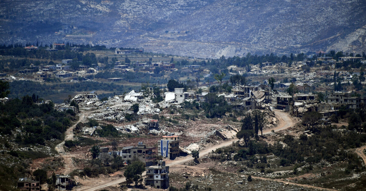 An Israeli flag hangs from a damaged building in a village inside south Lebanon close to the border as seen from northern Israel, June 18, 2026. REUTERS/Gil Eliyahu