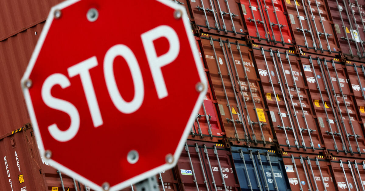 FILE PHOTO: A stop sign is pictured in front of shipping containers at the Port of Long Beach in Long Beach, California, U.S., July 11, 2025. REUTERS/Daniel Cole/File Photo