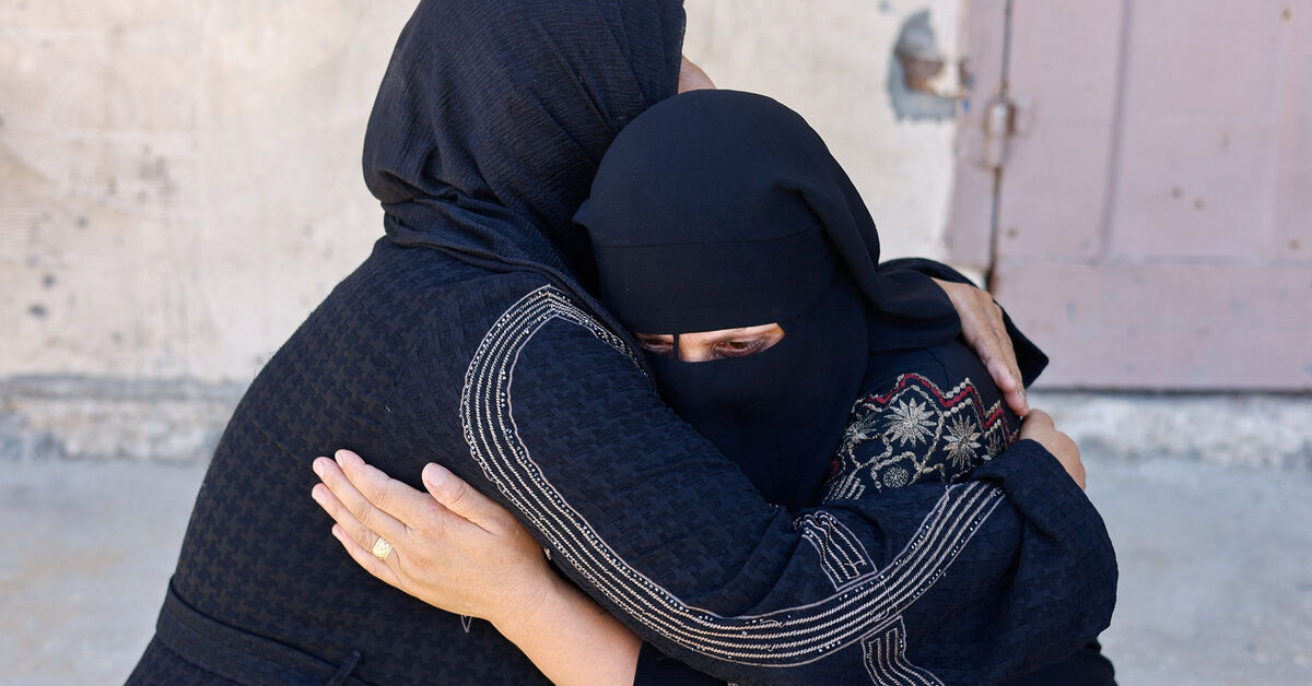 Mourners comfort each other, as they attend the funeral of Palestinian Saber Rabie, who was killed in an Israeli strike, according to medics, at Al-Aqsa Martyrs Hospital in Deir Al-Balah, in the central Gaza Strip, August 1, 2026. REUTERS/Mahmoud Issa