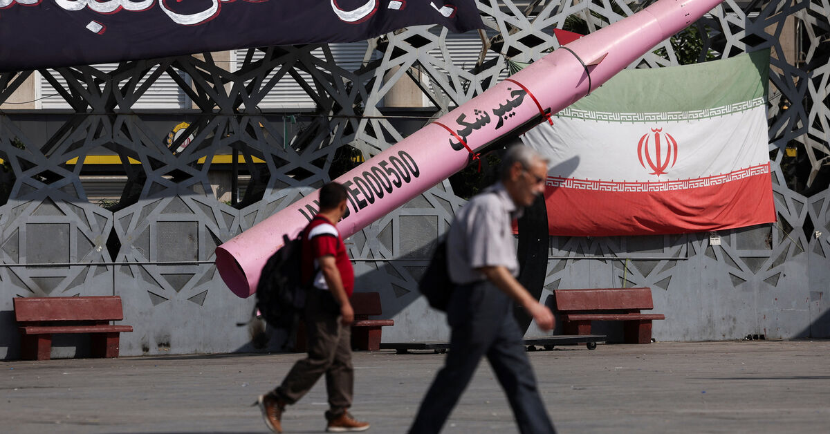 FILE PHOTO: People walk next to a symbolic mockup of an Iranian missile and an Iranian flag at Imam Hussein Square in Tehran, Iran, July 12, 2026. Majid Asgaripour/WANA (West Asia News Agency) via REUTERS/ File Photo