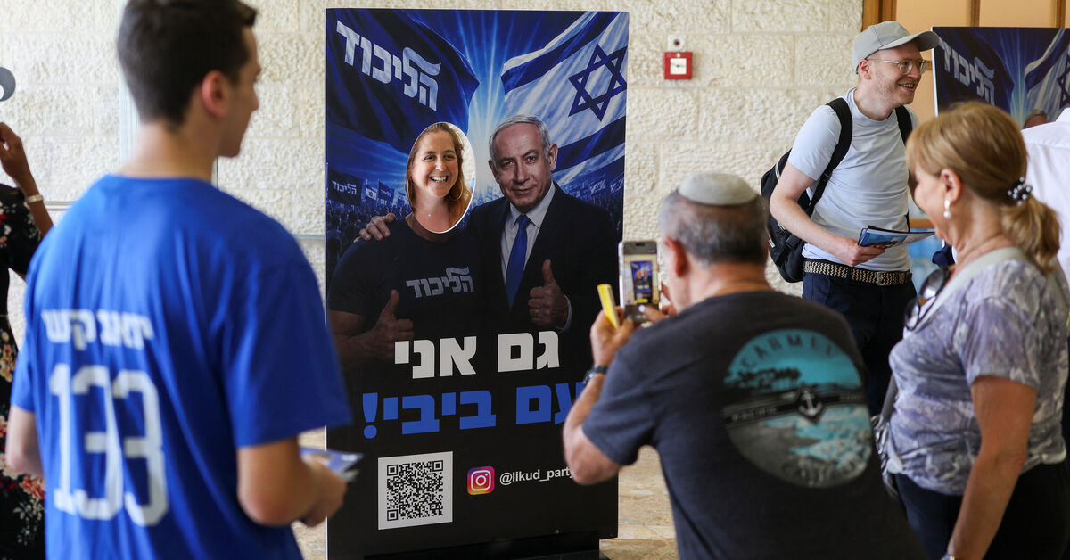 A woman poses with a photo stand-in featuring an image of Israeli Prime Minister Benjamin Netanyahu, on the day of the Likud party primaries list vote, ahead of Israel's general election in October, in Jerusalem, August 17, 2026. REUTERS/Ronen Zvulun