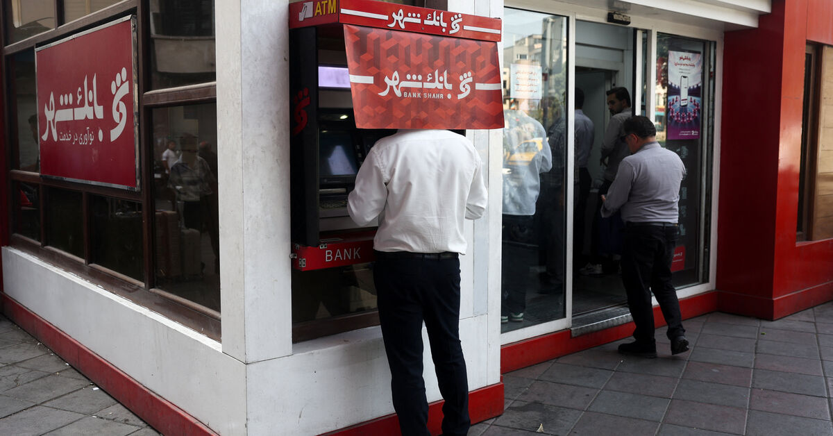 A man uses an ATM in front of a bank in Tehran, Iran, August 17, 2026. Majid Asgaripour/WANA (West Asia News Agency) via REUTERS ATTENTION EDITORS - THIS PICTURE WAS PROVIDED BY A THIRD PARTY. ISRAEL OUT. NO COMMERCIAL OR EDITORIAL SALES IN ISRAEL. NO ACCESS FOR ISRAELI MEDIA. NO USE BBC PERSIAN. NO USE VOA PERSIAN. NO USE MANOTO. NO USE IRAN INTERNATIONAL. NO USE RADIO FARDA. DIGITAL: NO USE BBC PERSIAN. NO USE VOA PERSIAN. NO USE MANOTO. NO USE IRAN INTERNATIONAL. NO USE RADIO FARDA.