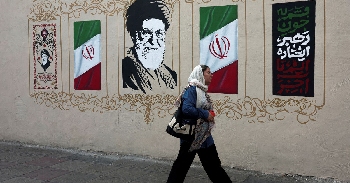FILE PHOTO: A woman walks by a mural depicting Iran's late Supreme Leader Ayatollah Ali Khamenei, on a street in Tehran, Iran, August 13, 2026. Majid Asgaripour/WANA (West Asia News Agency) via REUTERS/File Photo