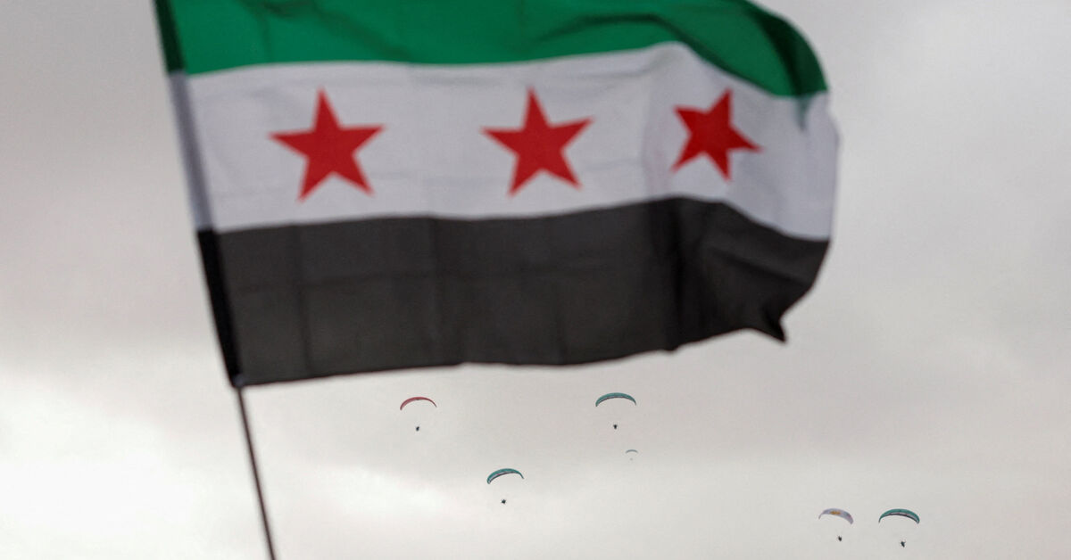 A flag flies in the wind at Ummayad Square in Damascus, Syria December 8, 2025. REUTERS/Yamam al Shaar