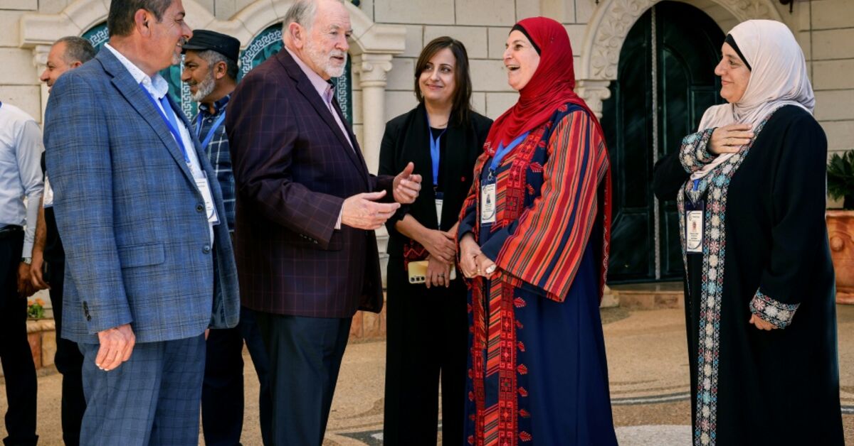 US Ambassador to Israel Mike Huckabee is greeted by members of the local municipality as he arrives to visit the home of a