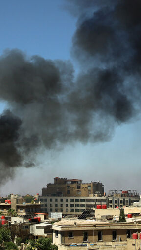 image of Suwayda, Syria with smoke billowing up from an explosion