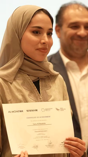 Student holding certificate