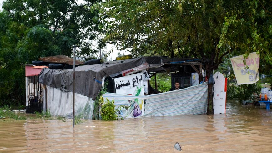 A man looks from a shack surrounded by heavy flooding in Iran's northwestern city of Astara, Gilan province, after severe floods hit the northern part of the country, Sept. 18, 2023. 