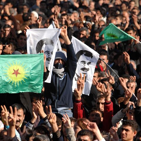 A boy waves a flag of jailed PKK leader Abdullah Ocalan as tens of thousands of Kurds gather during a rally of the DTP.